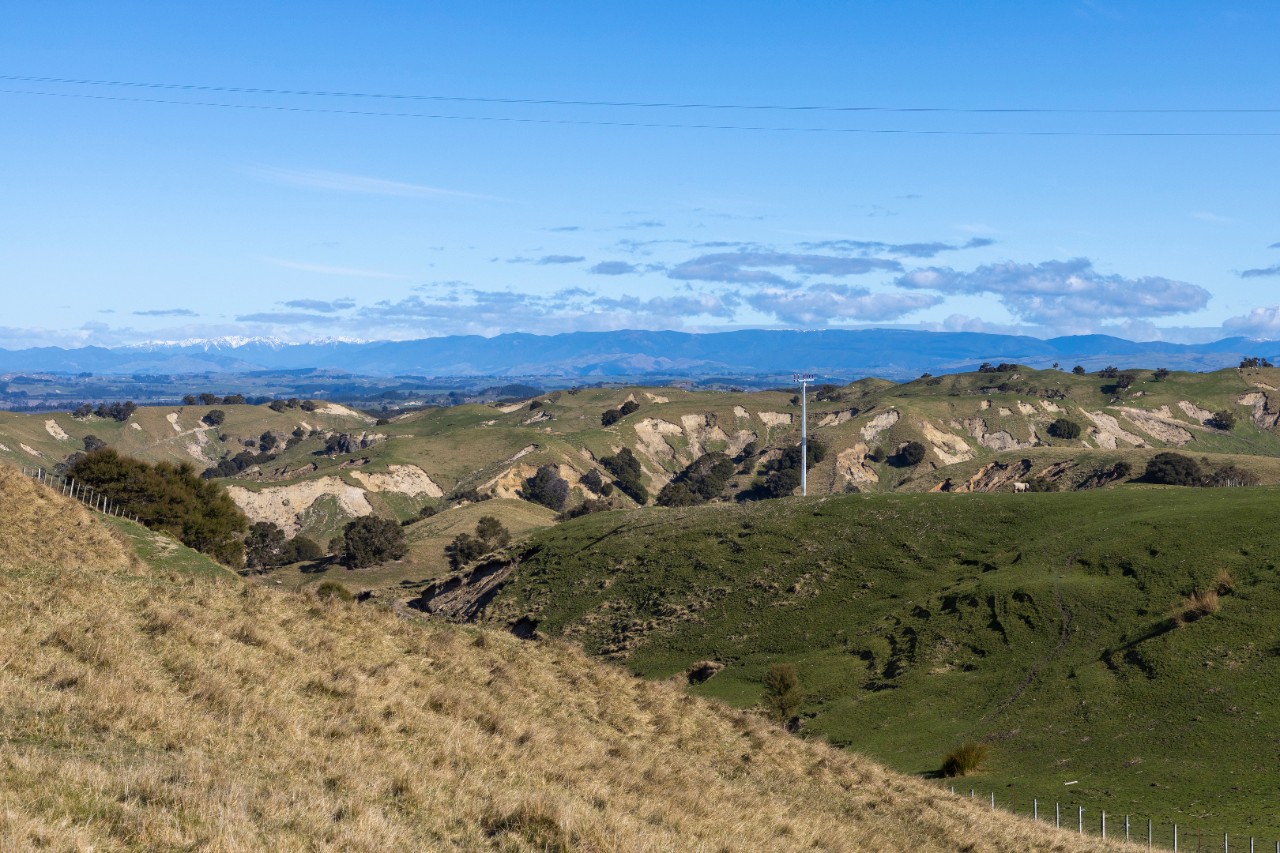 Looking south over farmlands near Puketitiri, with deep slip scars across the landscape, caused by Cyclone Gabrielle.