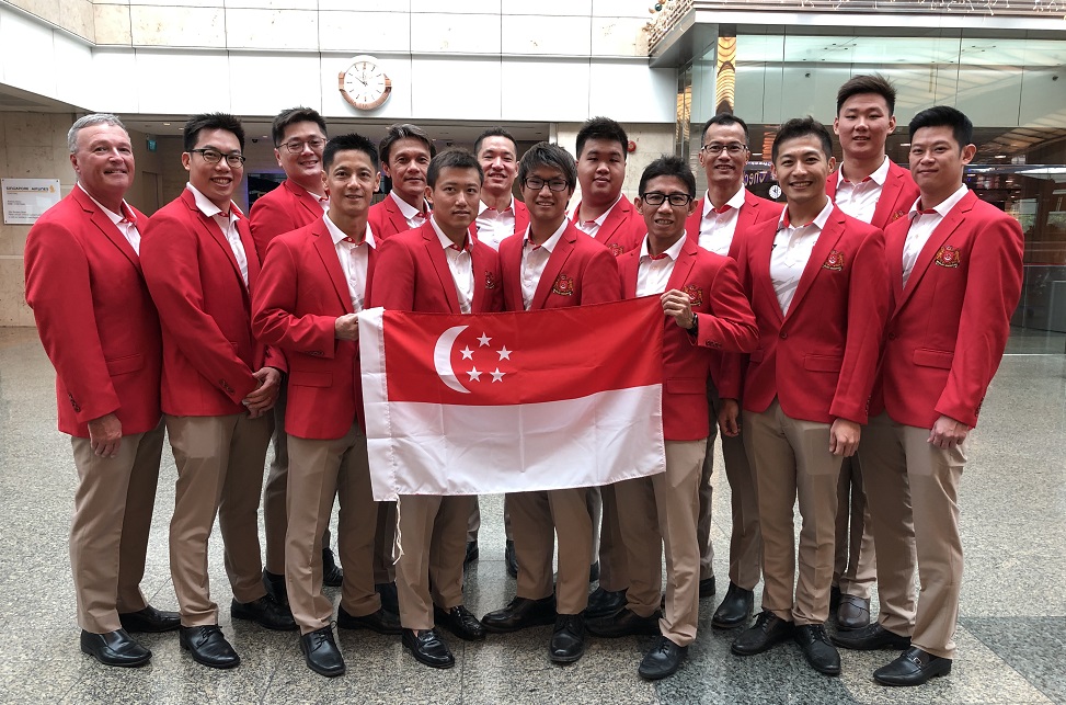 The men’s team at Changi Airport, Singapore on their way to the SEA Games in Manila (Simon, holding left corner of flag)