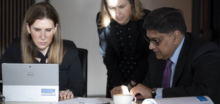 Finalising the trading update figures with (L-R) Group General Manager Investor Relations Jill Campbell, Senior M&A Advisor Kylie Bundrock and CFO Farhan Faruqui Source: Arsineh Houspian