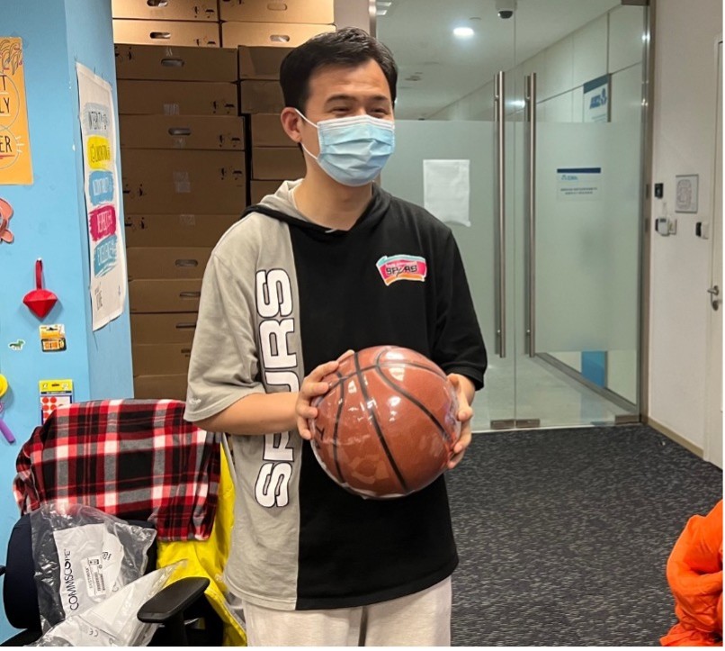 Emergency team member Rex Zhang enjoys gifts of his favourite sport to lift team spirits